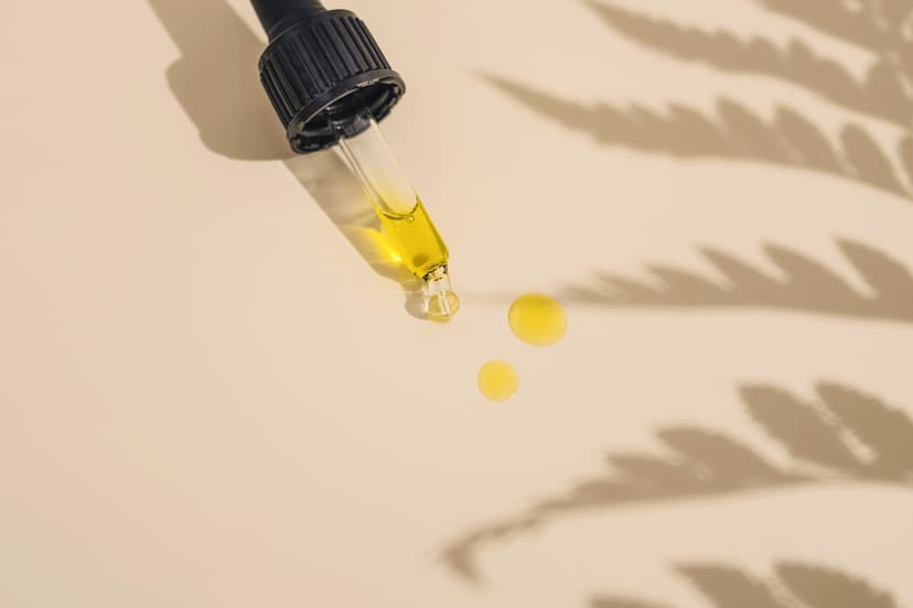 Golden skincare serum being dispensed from dropper bottle